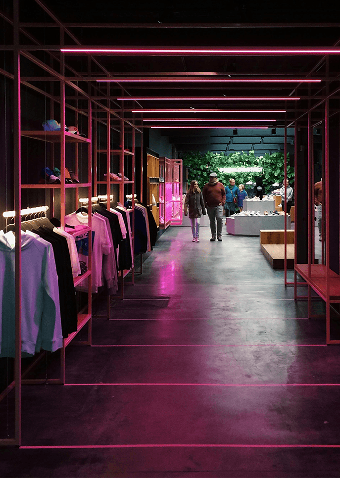 Retail display showroom with illuminated shelving and apparel